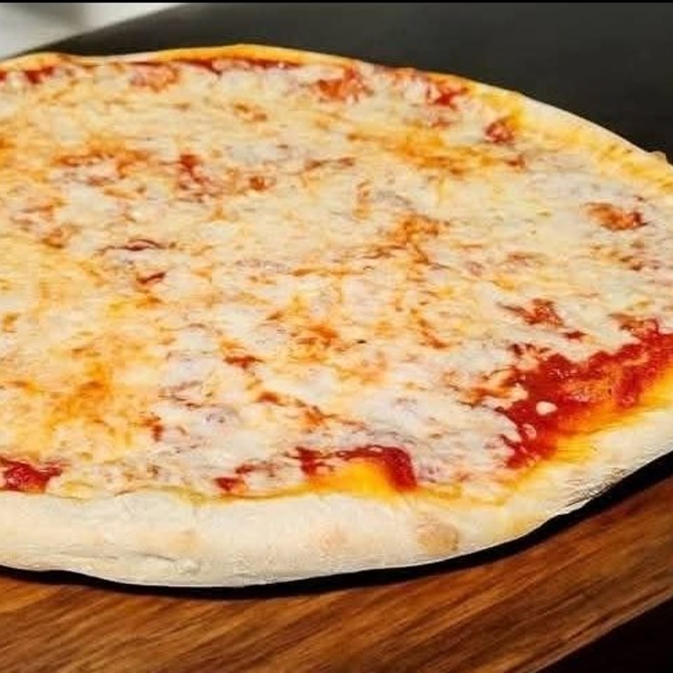 Round cheese pizza with melted mozzarella and red sauce on a wooden cutting board.